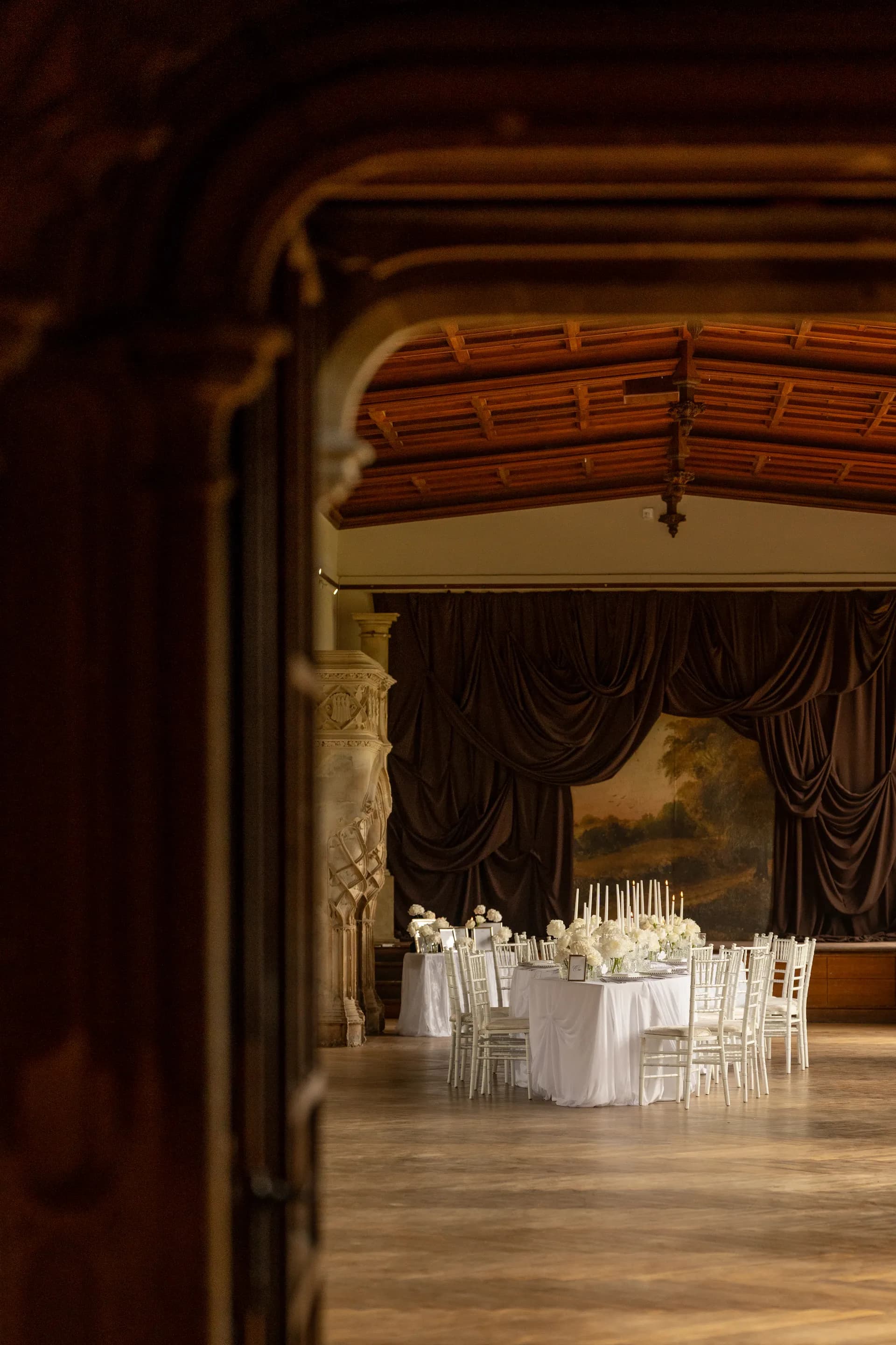 The Music Room stage dressed with drapes, candles and a table of flowers